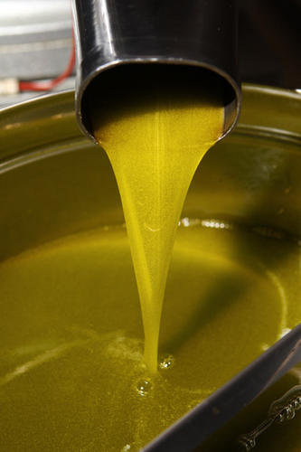 Extra Virgin Olive Oil being poured into a pan
